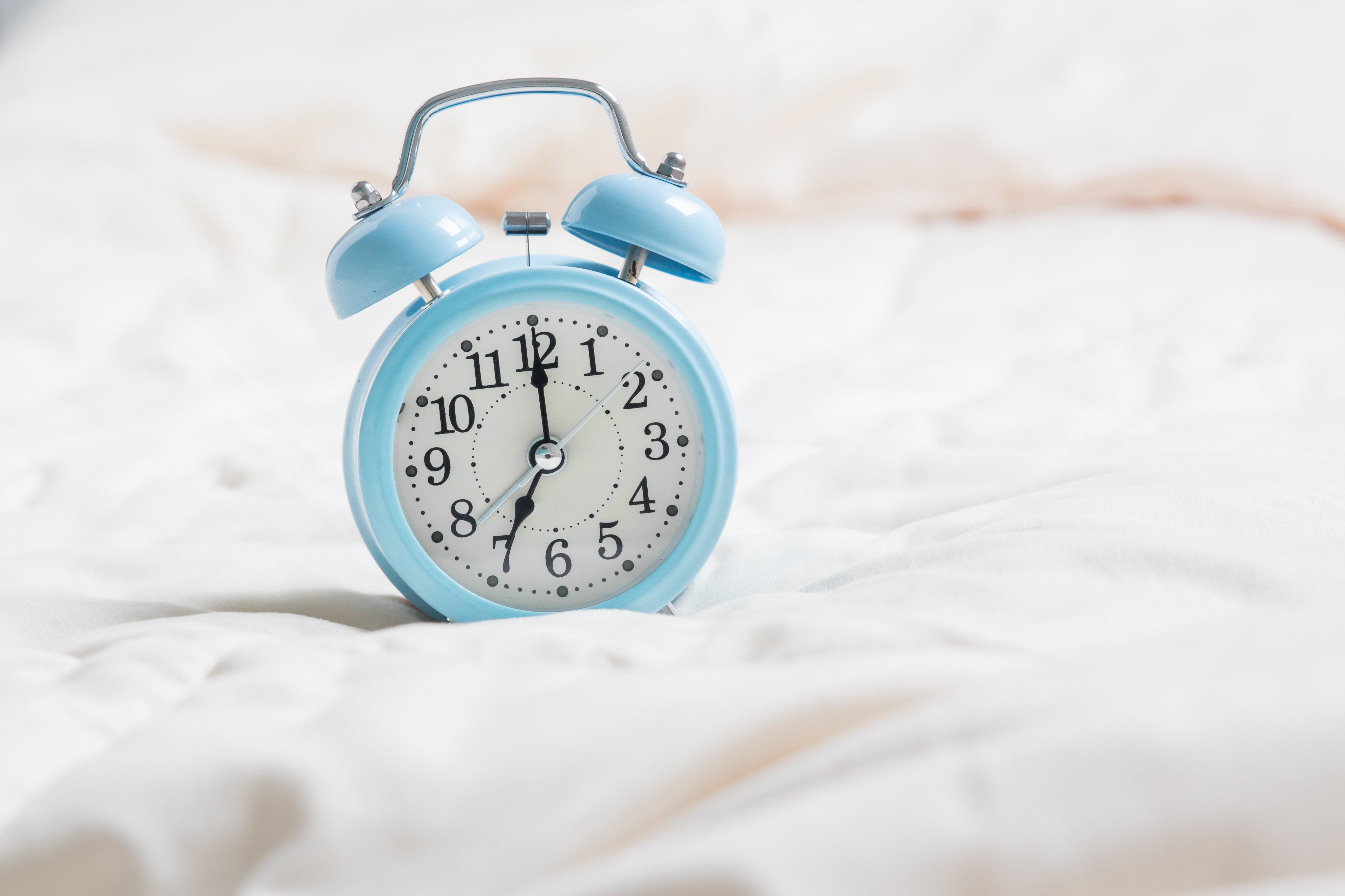 Canva - alarm clock on bed